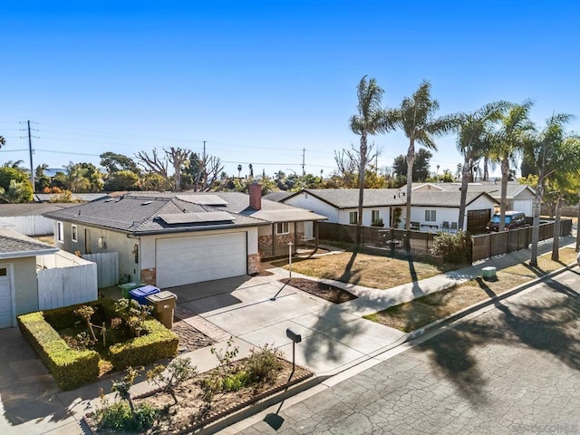 single story home featuring a garage and solar panels