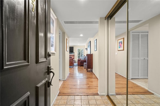 corridor featuring light tile patterned floors