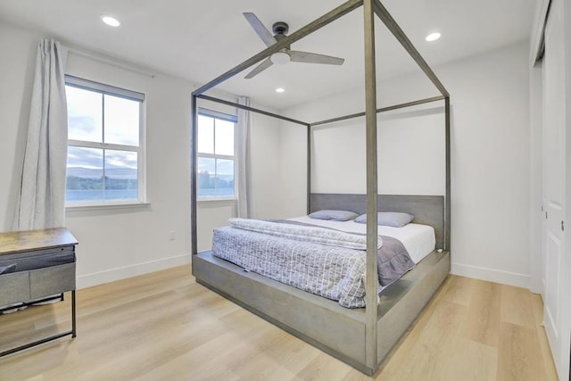 bedroom with ceiling fan and light hardwood / wood-style flooring