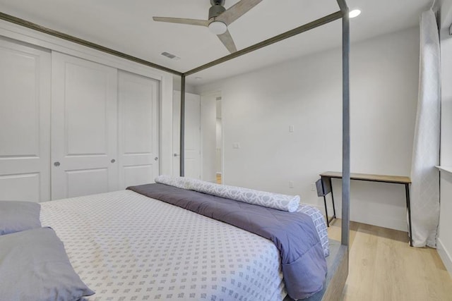 bedroom featuring a closet, ceiling fan, and light hardwood / wood-style flooring