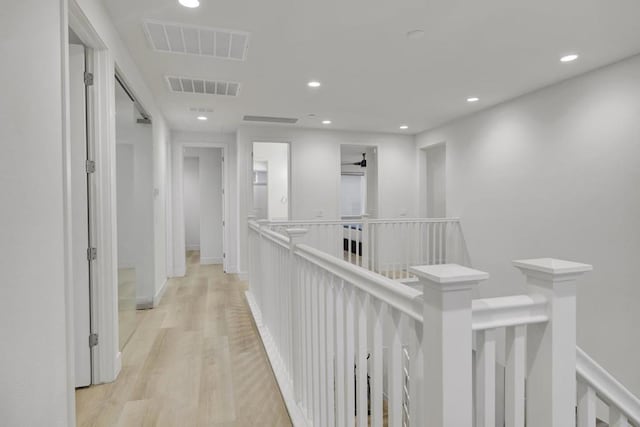 corridor with light hardwood / wood-style floors