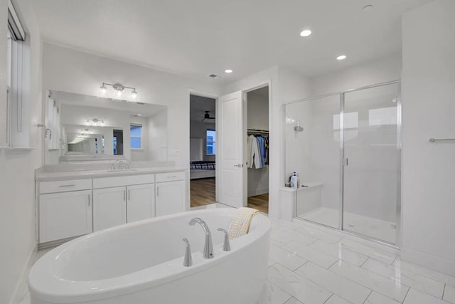 bathroom featuring plus walk in shower and vanity