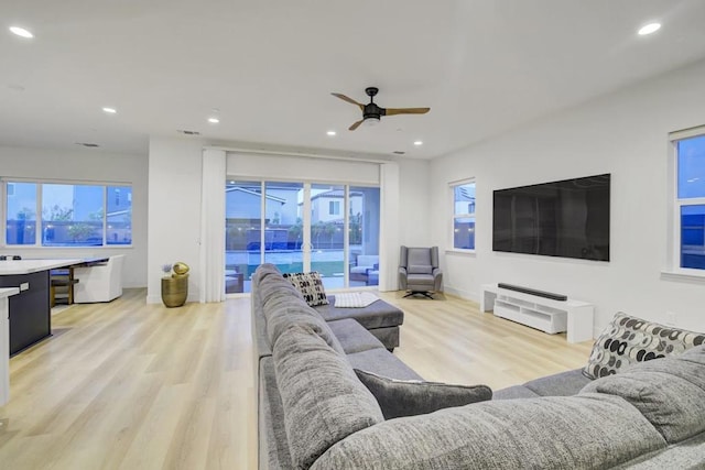 living room featuring ceiling fan and light hardwood / wood-style flooring