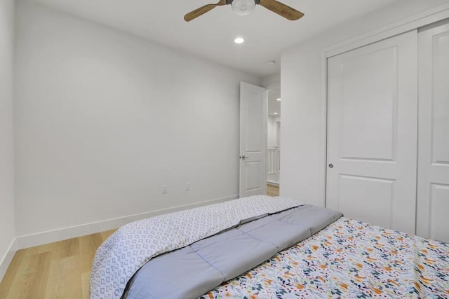 bedroom featuring a closet, ceiling fan, and light hardwood / wood-style floors