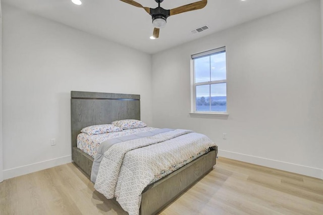 bedroom with ceiling fan and light wood-type flooring