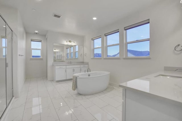 bathroom with vanity and a tub