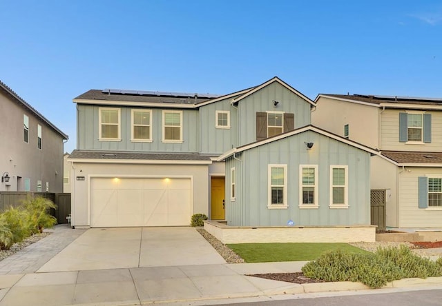 view of front of home featuring solar panels and a garage