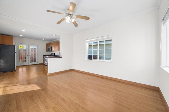 unfurnished living room with ornamental molding, ceiling fan, french doors, and light wood-type flooring