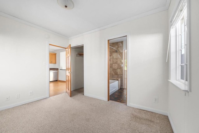 unfurnished bedroom with multiple windows, ensuite bathroom, carpet floors, and crown molding