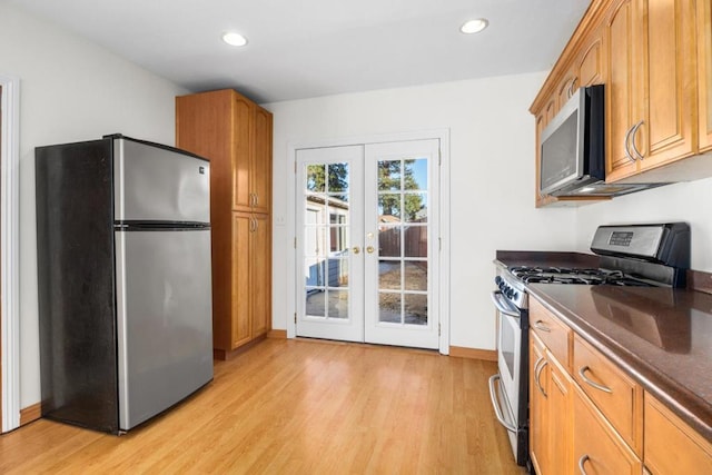 kitchen featuring light hardwood / wood-style floors, stainless steel appliances, and french doors