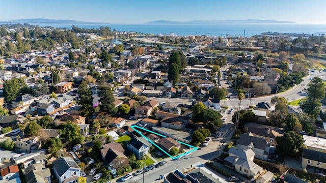 drone / aerial view featuring a water and mountain view