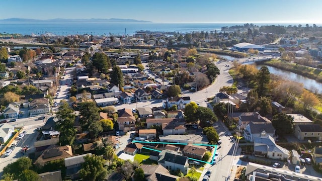 drone / aerial view featuring a water and mountain view