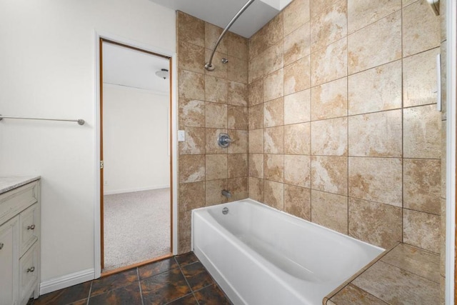 bathroom with vanity and tiled shower / bath