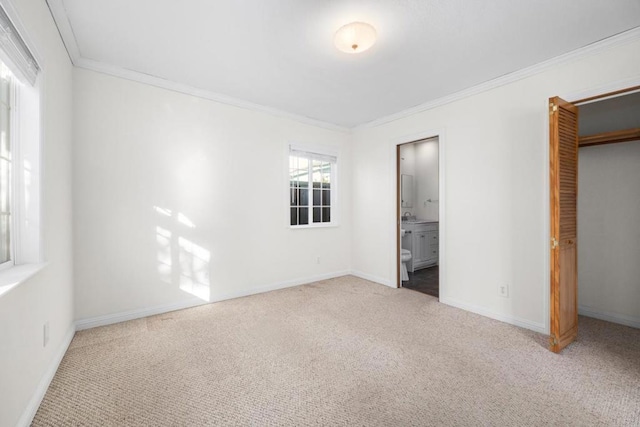 unfurnished bedroom with ornamental molding, light colored carpet, connected bathroom, and multiple windows