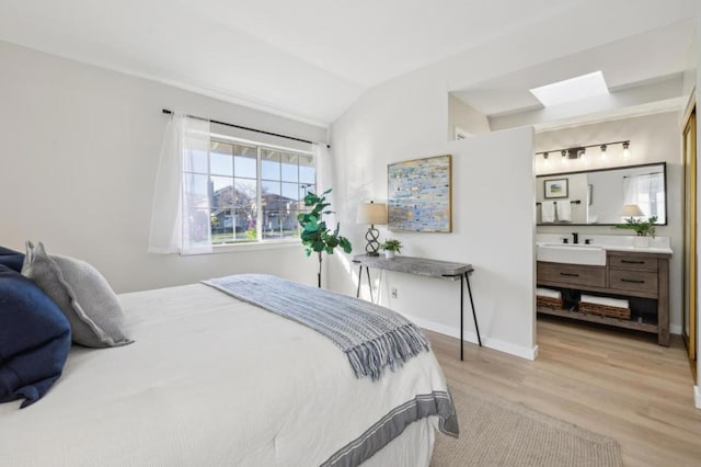 bedroom featuring lofted ceiling and light hardwood / wood-style floors