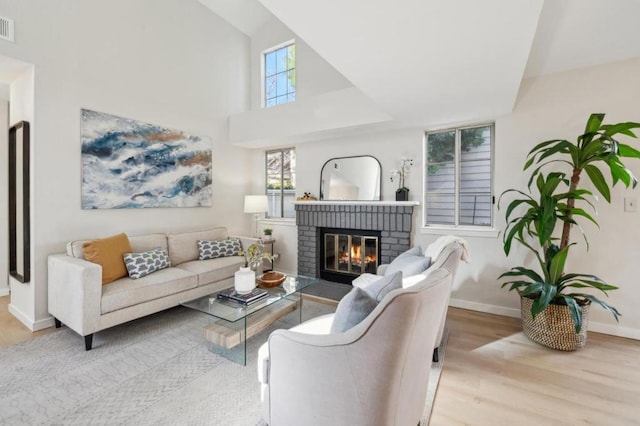 living room with a fireplace and light hardwood / wood-style flooring