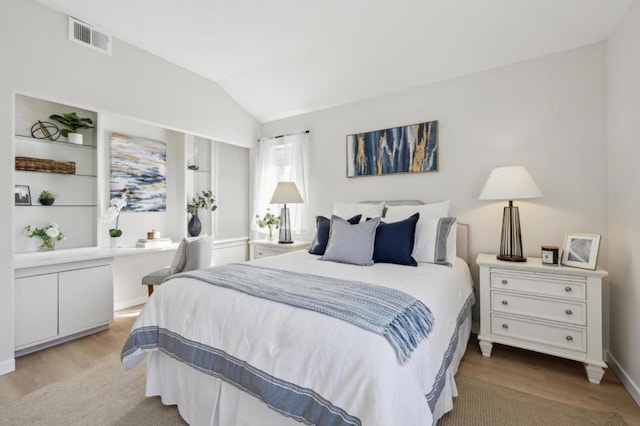 bedroom featuring vaulted ceiling and light hardwood / wood-style flooring