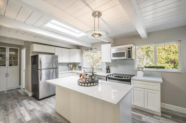 kitchen with white cabinetry, tasteful backsplash, and stainless steel appliances