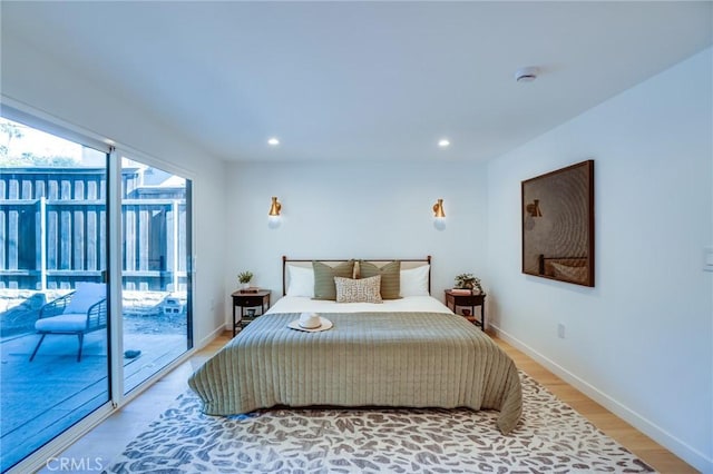 bedroom featuring hardwood / wood-style floors and access to outside