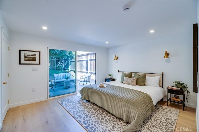 bedroom featuring access to exterior and light hardwood / wood-style flooring