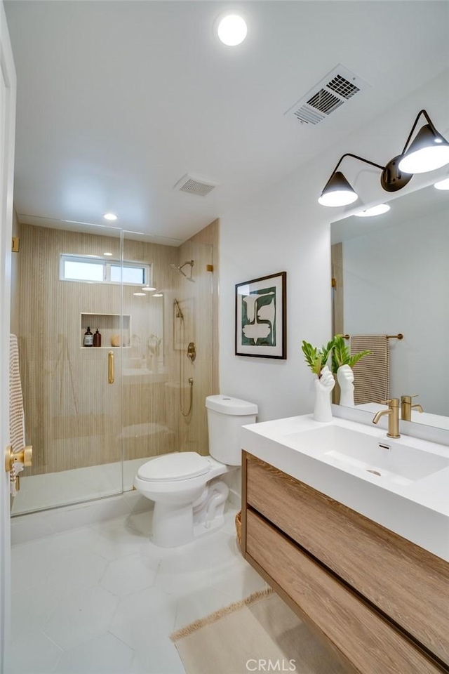 bathroom with toilet, vanity, and walk in shower