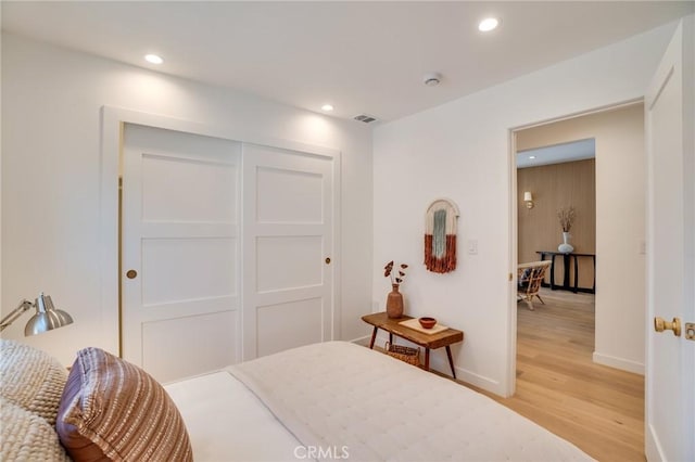 bedroom featuring a closet and light hardwood / wood-style floors