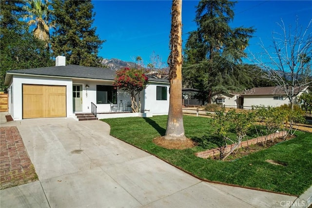 ranch-style home featuring a front lawn, a garage, and covered porch