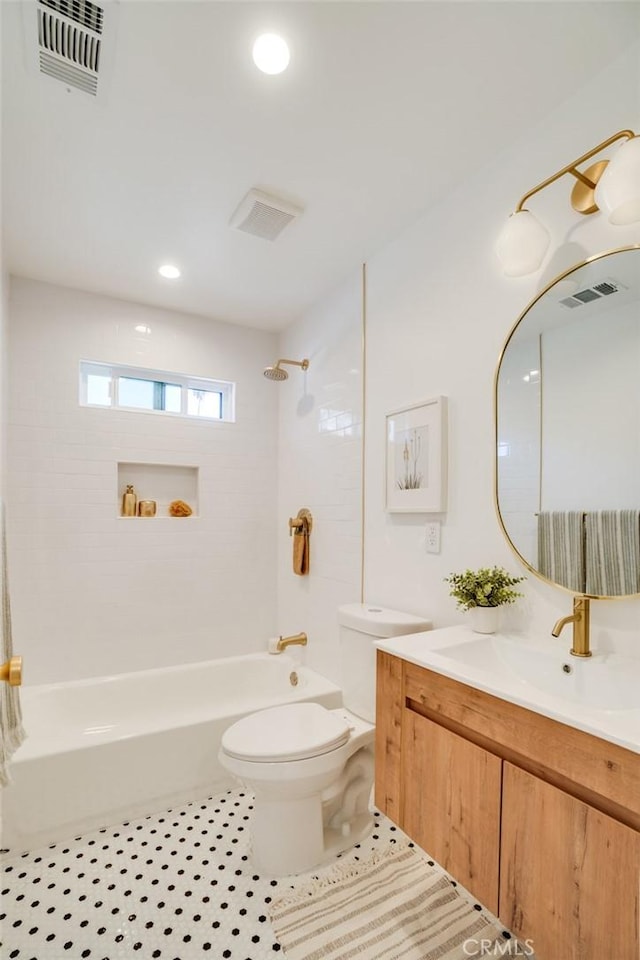 full bathroom featuring toilet, tiled shower / bath combo, tile patterned flooring, and vanity