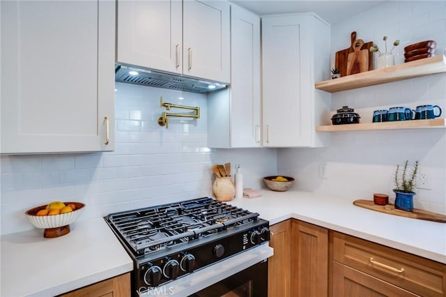 kitchen featuring white cabinets, backsplash, and black gas range