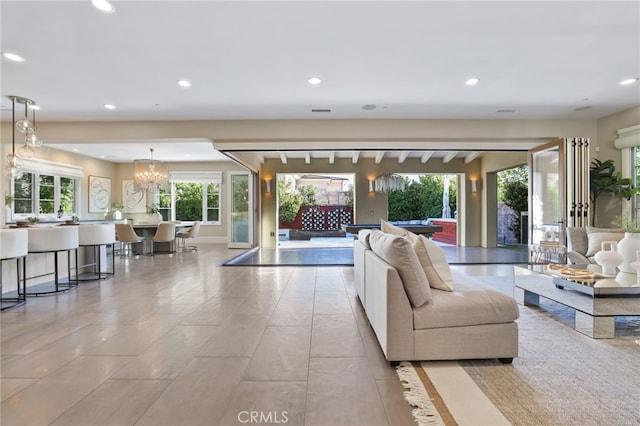 living room with a notable chandelier and light tile patterned flooring