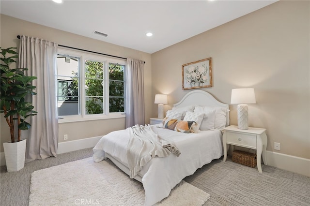 bedroom featuring light colored carpet