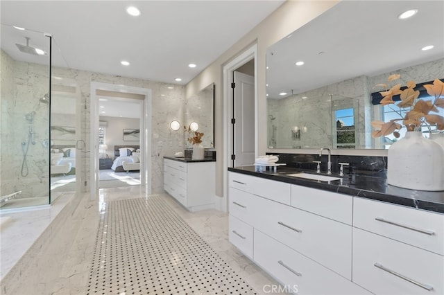 bathroom featuring an enclosed shower and vanity