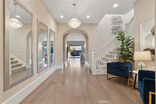 foyer entrance featuring an inviting chandelier