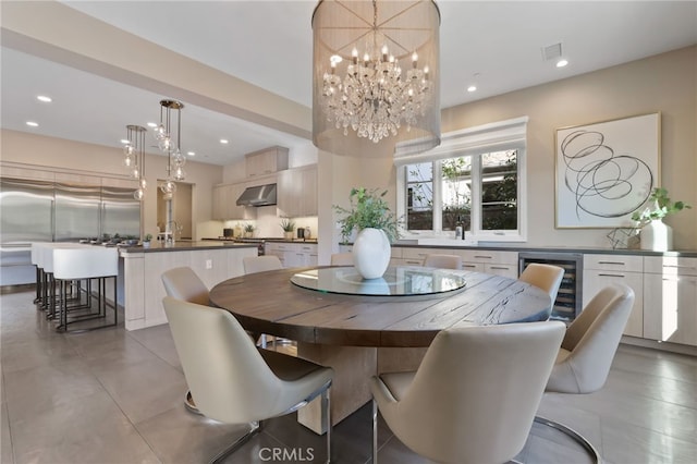 dining space with beverage cooler and a chandelier