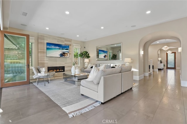 living room featuring a tiled fireplace