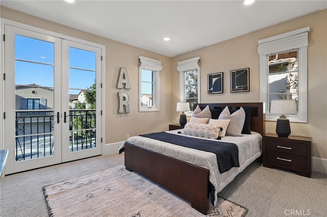 bedroom with french doors, access to exterior, and light colored carpet