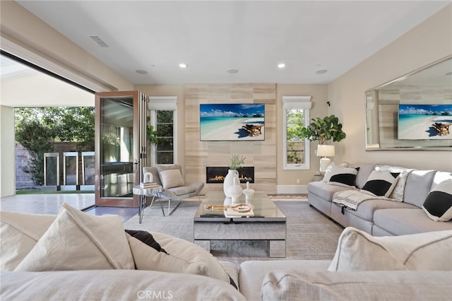 living room featuring a tiled fireplace