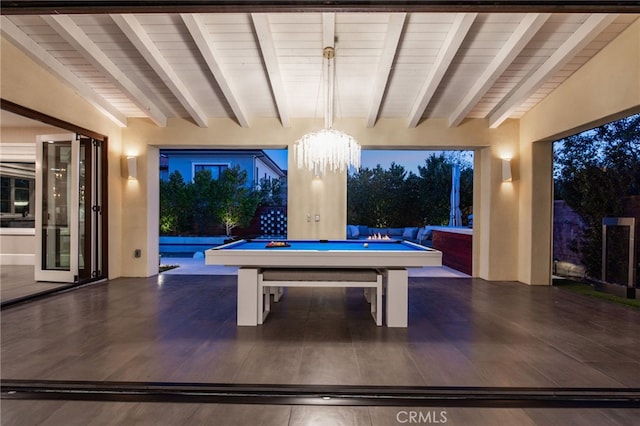 recreation room featuring billiards, lofted ceiling with beams, and a chandelier