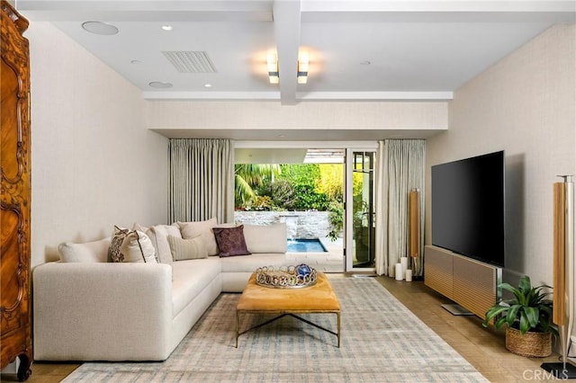 living room featuring light hardwood / wood-style flooring and beamed ceiling