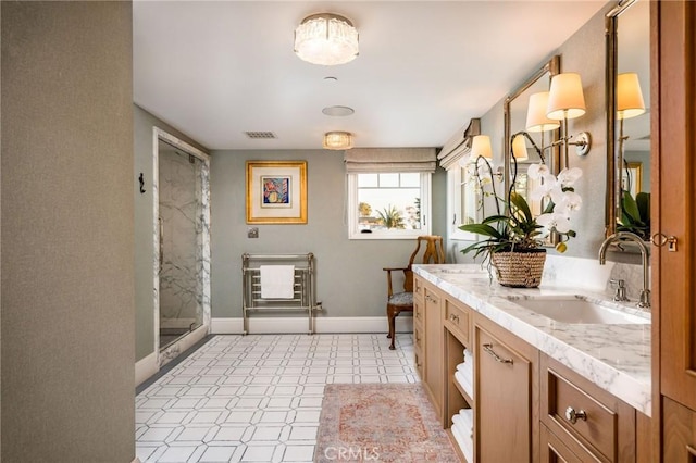 bathroom with a shower with door and vanity