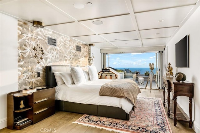 bedroom featuring light hardwood / wood-style flooring and coffered ceiling