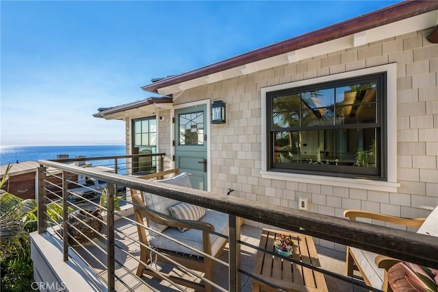 balcony featuring a water view