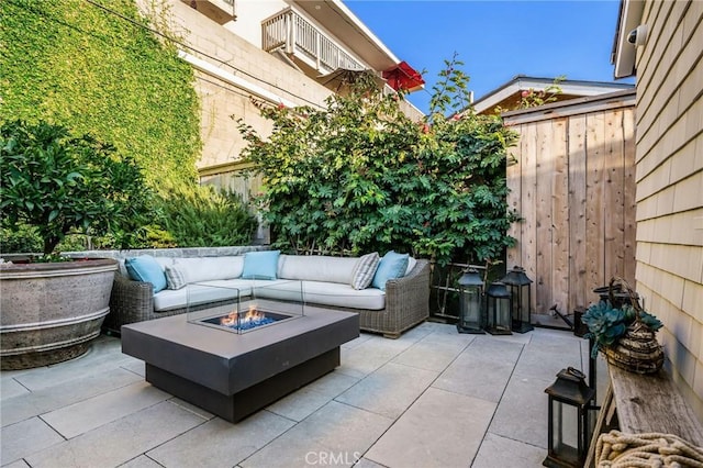 view of patio / terrace featuring an outdoor living space with a fire pit