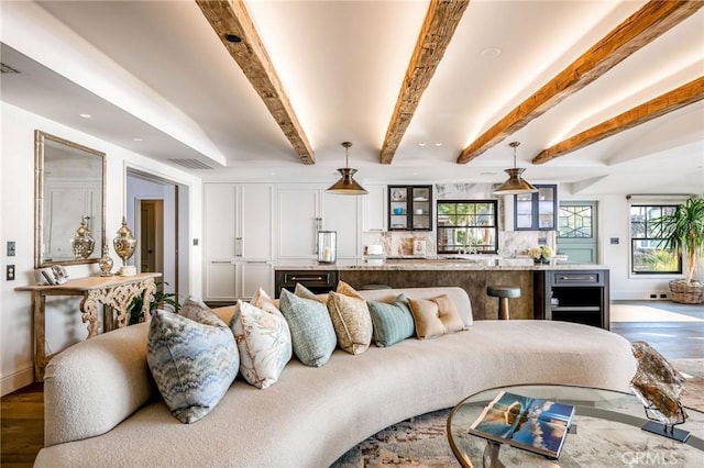 interior space featuring a wealth of natural light, hardwood / wood-style flooring, and beamed ceiling