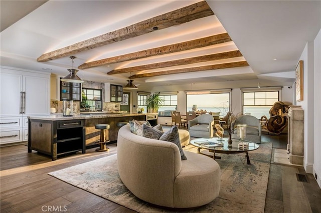 living room with beamed ceiling and dark hardwood / wood-style flooring