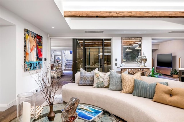 living room with beamed ceiling and hardwood / wood-style floors