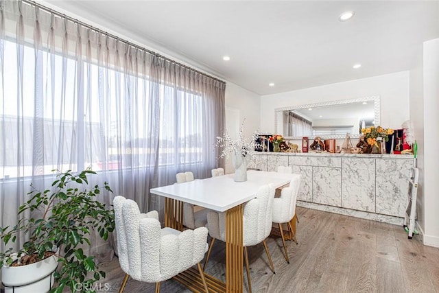 dining space with light hardwood / wood-style floors