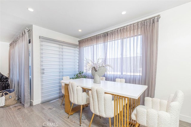 dining space with light wood-type flooring and plenty of natural light