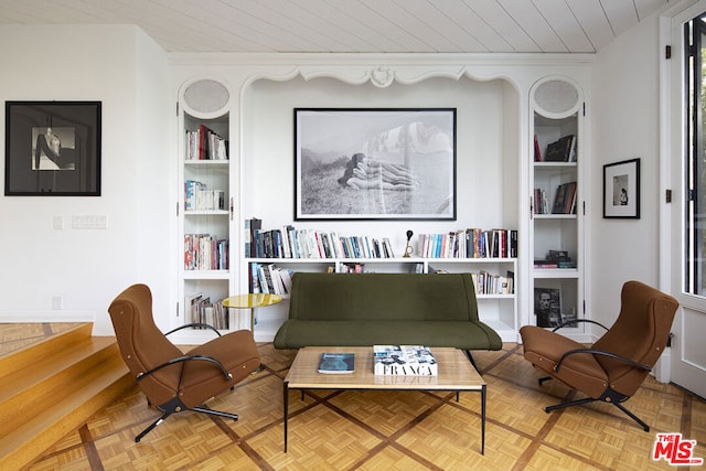 living room featuring wooden ceiling, built in shelves, and light parquet flooring