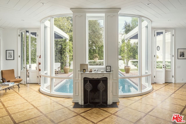 entryway featuring wooden ceiling, plenty of natural light, and light parquet floors